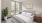 a bedroom with a bed and a plant