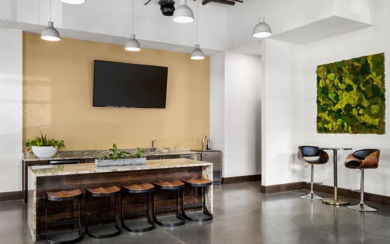a kitchen with a bar and stools